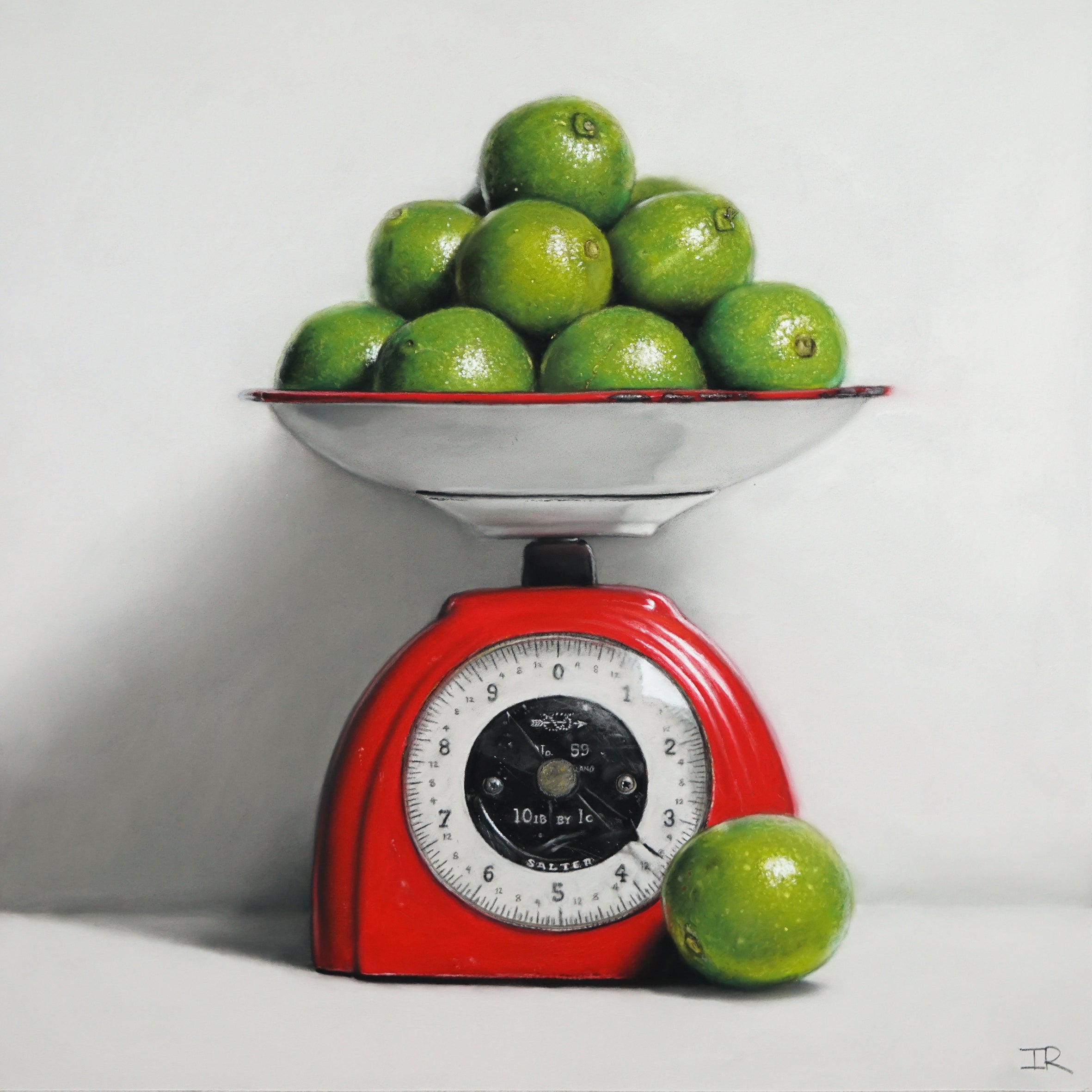 Vintage red kitchen scale with green limes on a white background