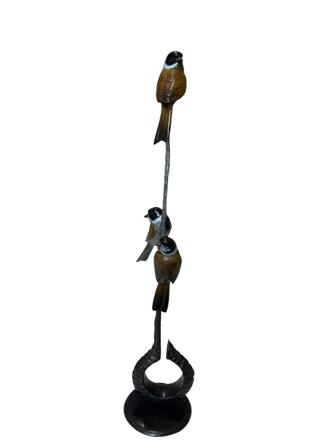 Decorative metal sculpture of three birds on a branch with a hook at the bottom on a white background.