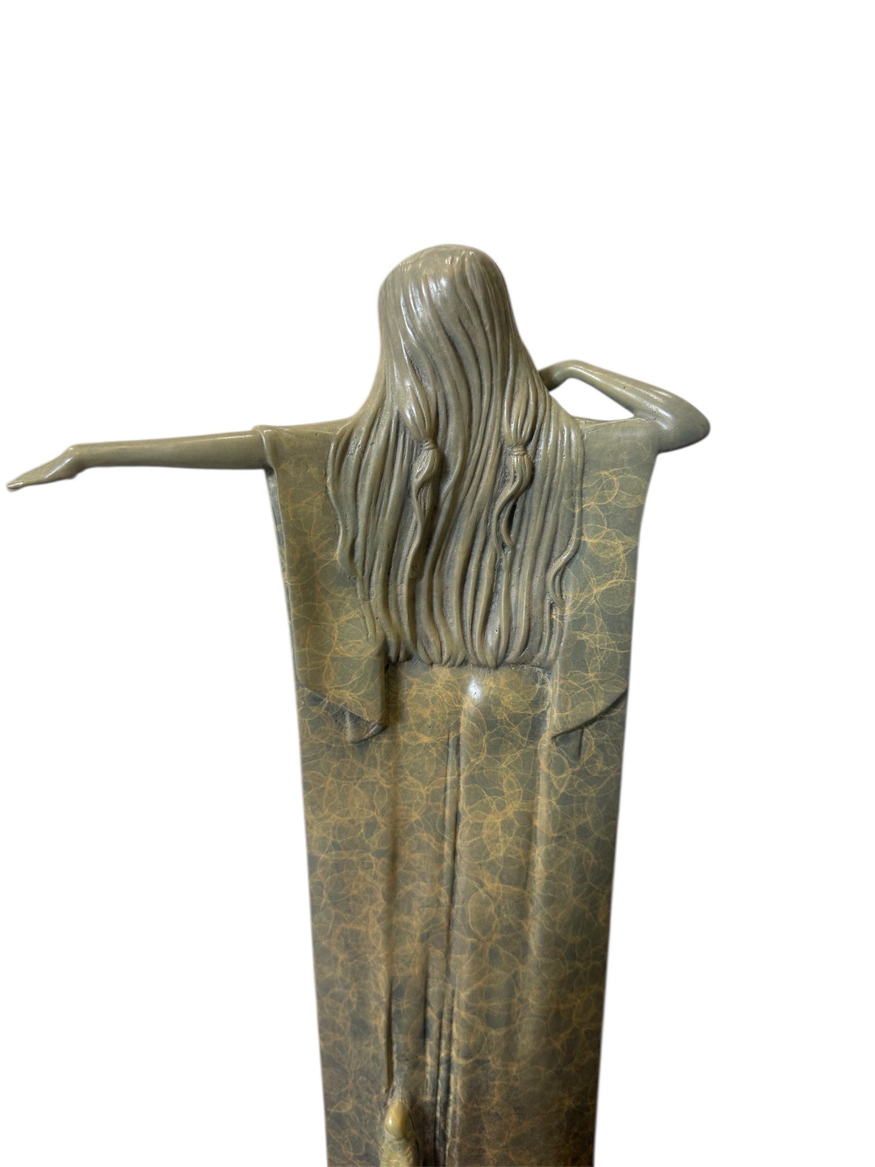 Bronze statue of a woman with outstretched arms on a white background