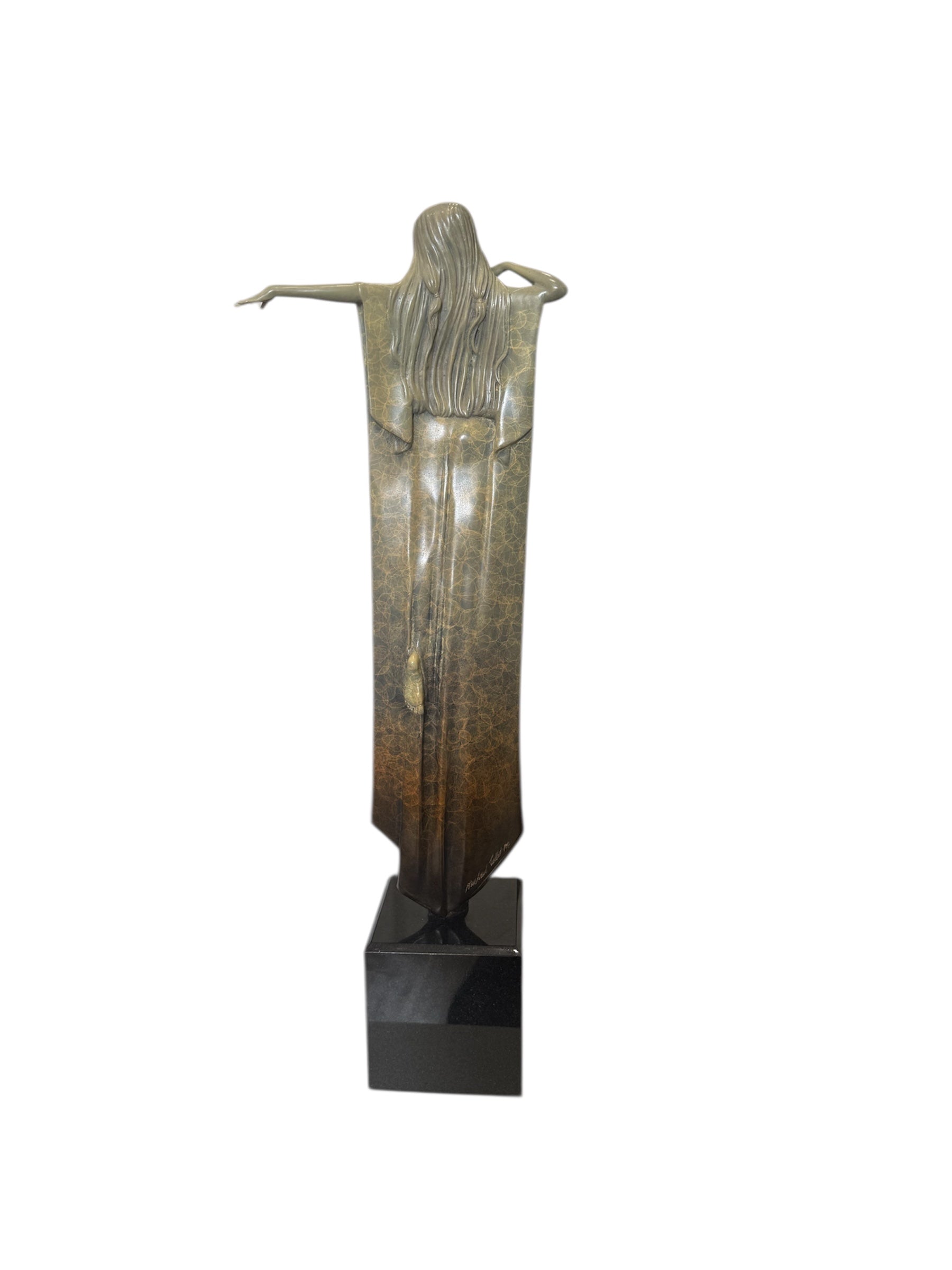 bronze sculpture of a woman with outstretched arm and flowing hair on a black marble plynth