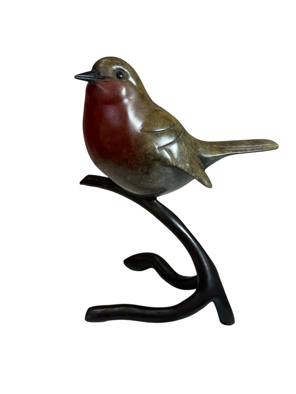 Bronze sculpture of a bird perched on a branch against a white background