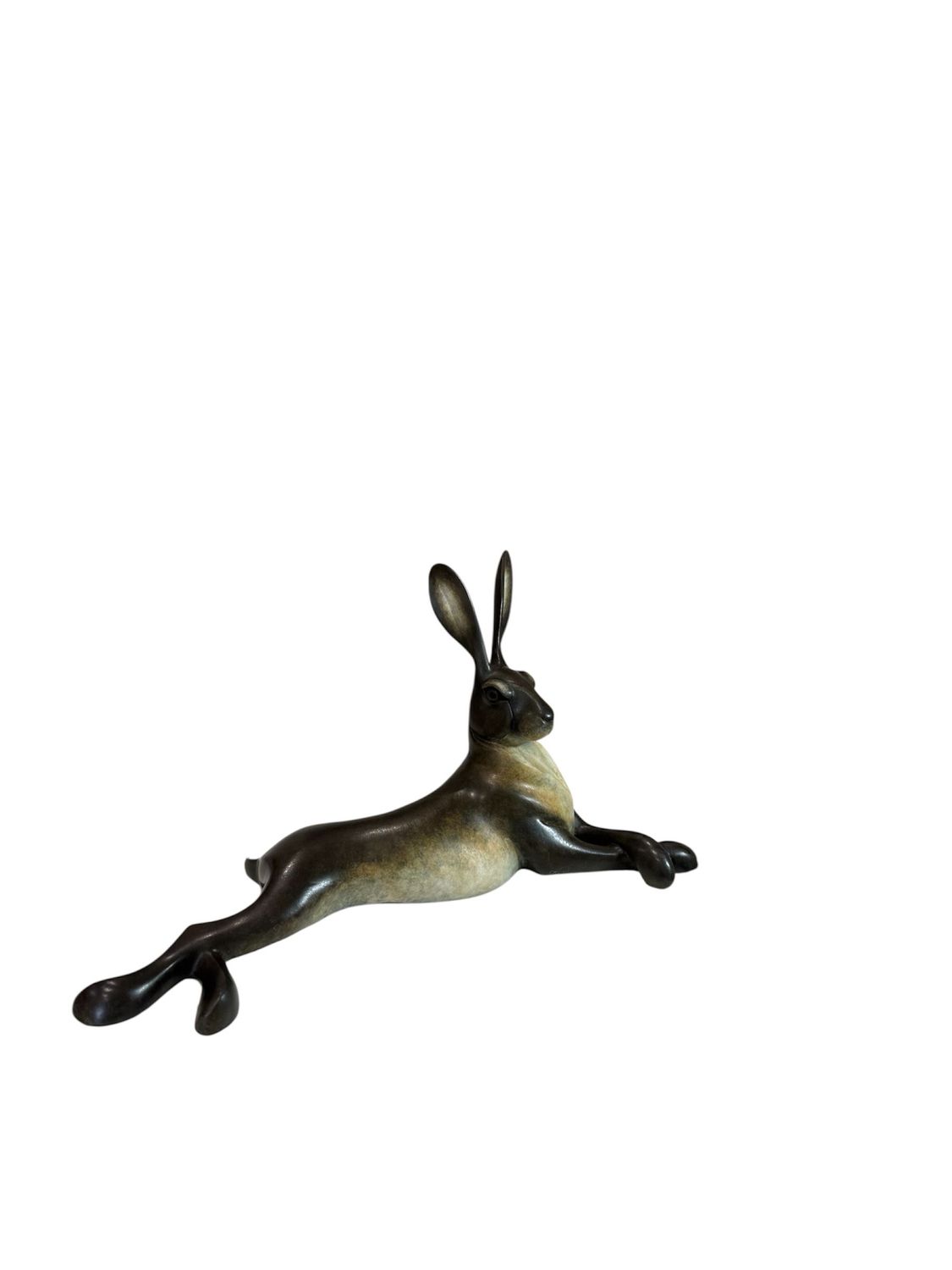 Bronze sculpture of a lying hare on a white background