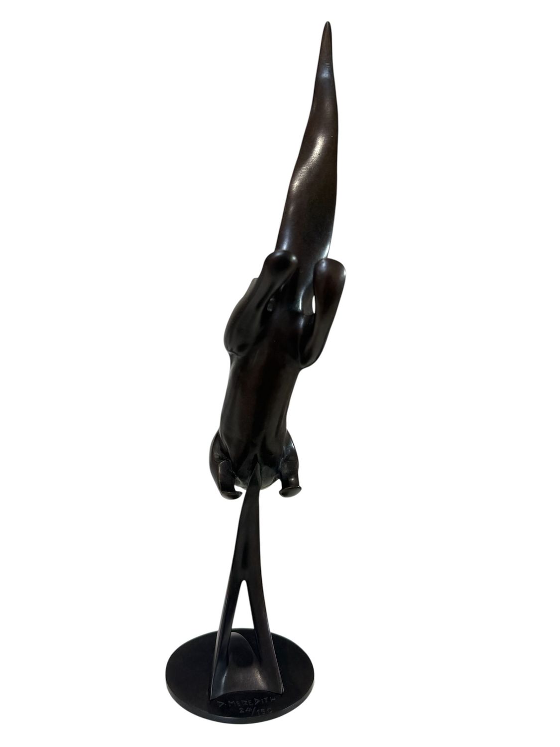 Black sculpture of an otter on a white background