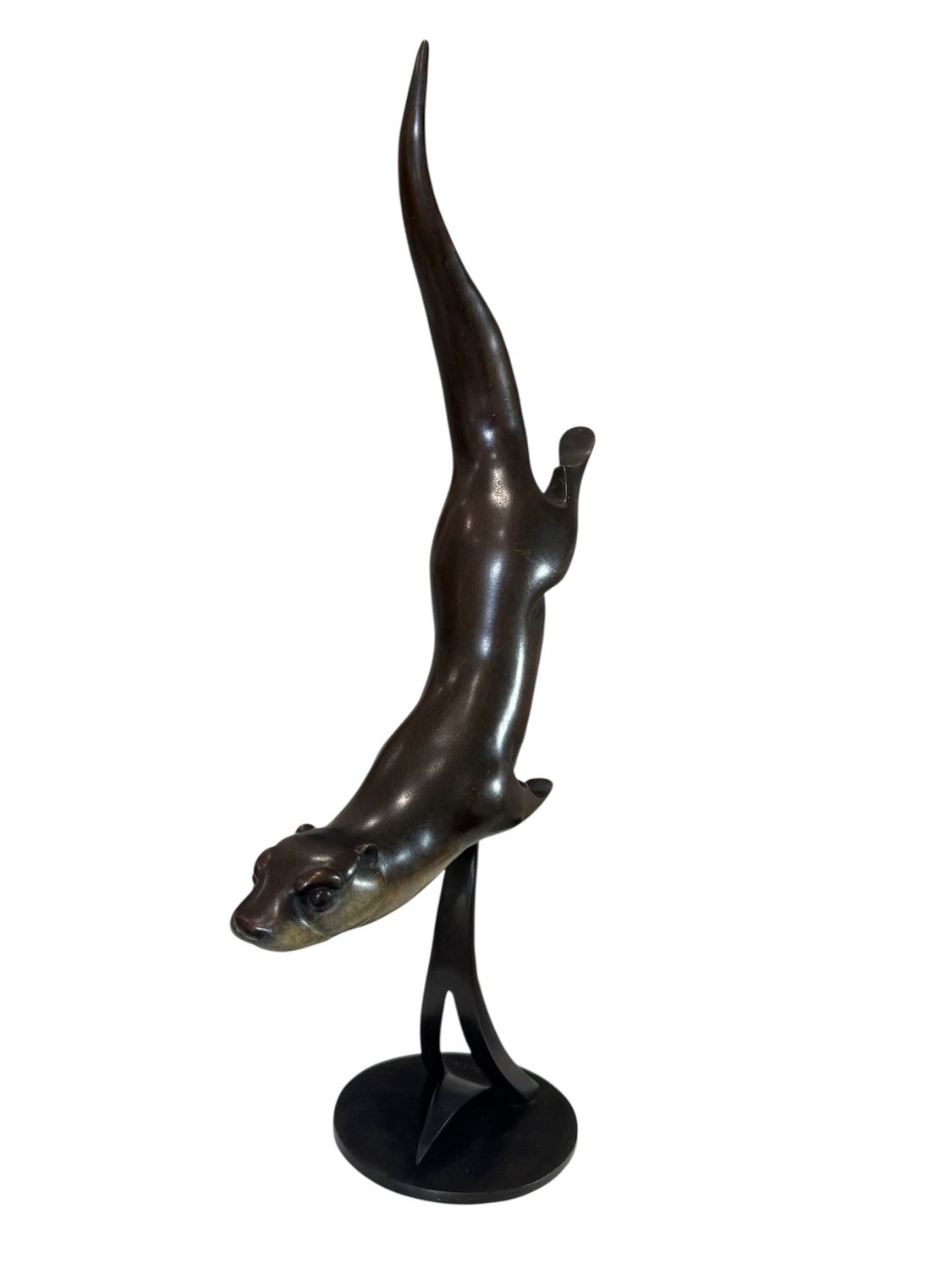 Bronze sculpture of a leaping dolphin on a white background