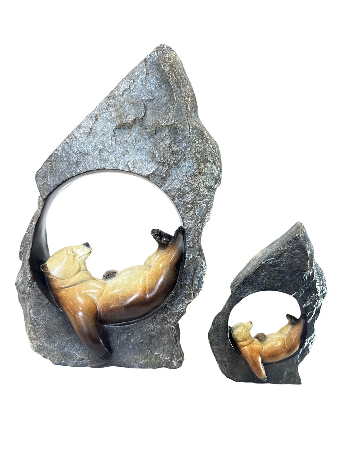 Two bronze sculptures of bears in a naturalistic setting on a white background