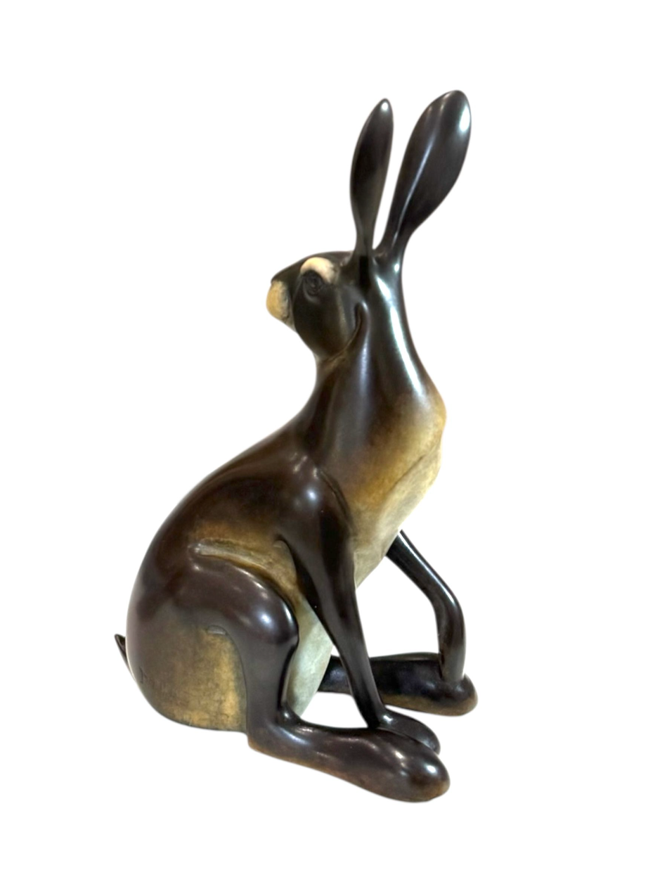 Bronze sculpture of a rabbit on a white background
