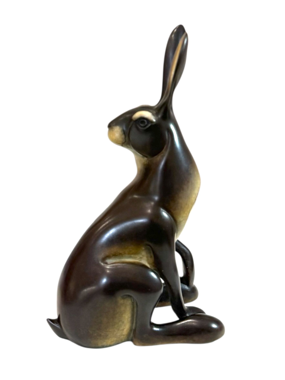 Bronze sculpture of a rabbit on a white background