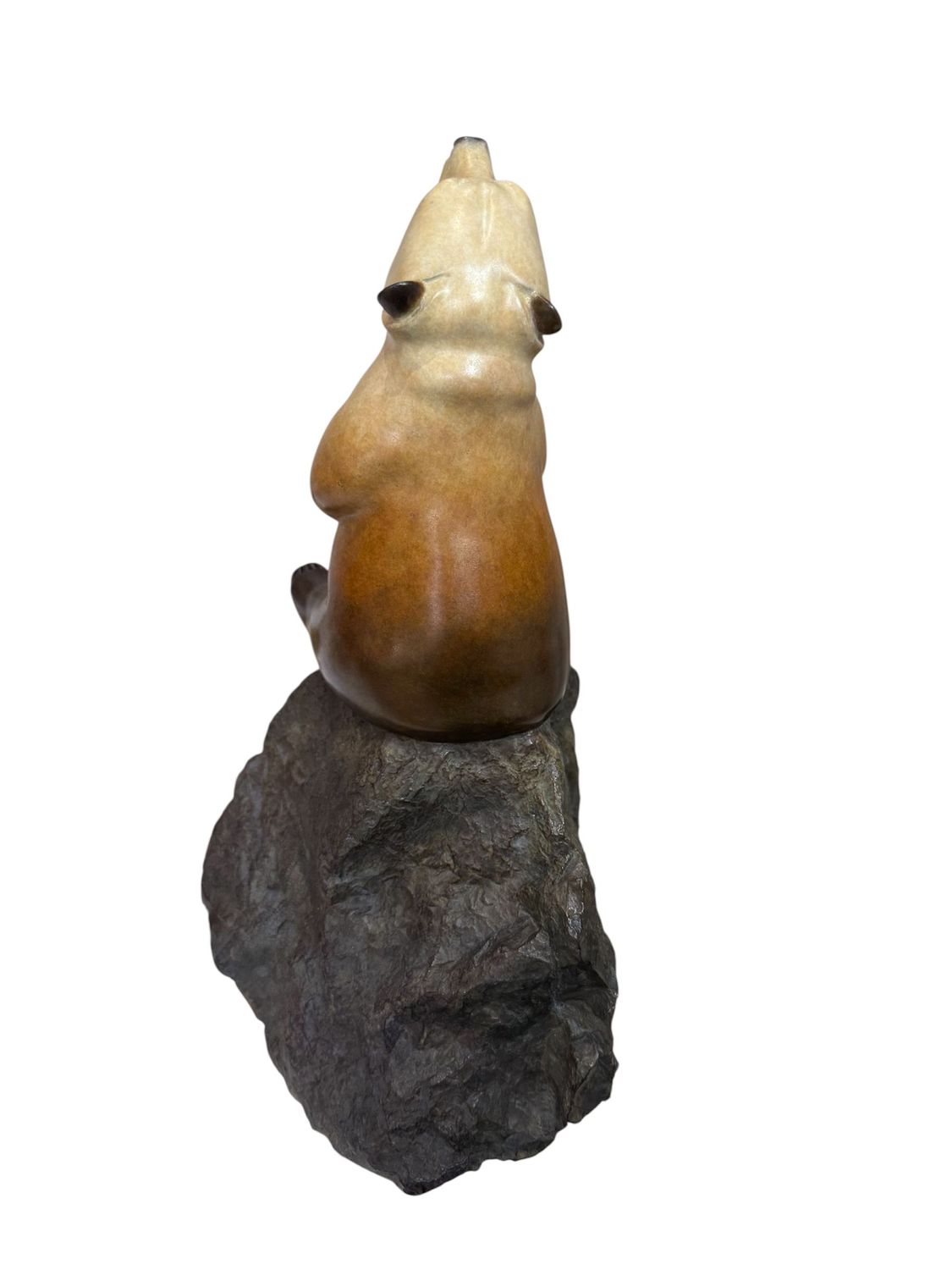 Ceramic bear sculpture on a rock with a white background