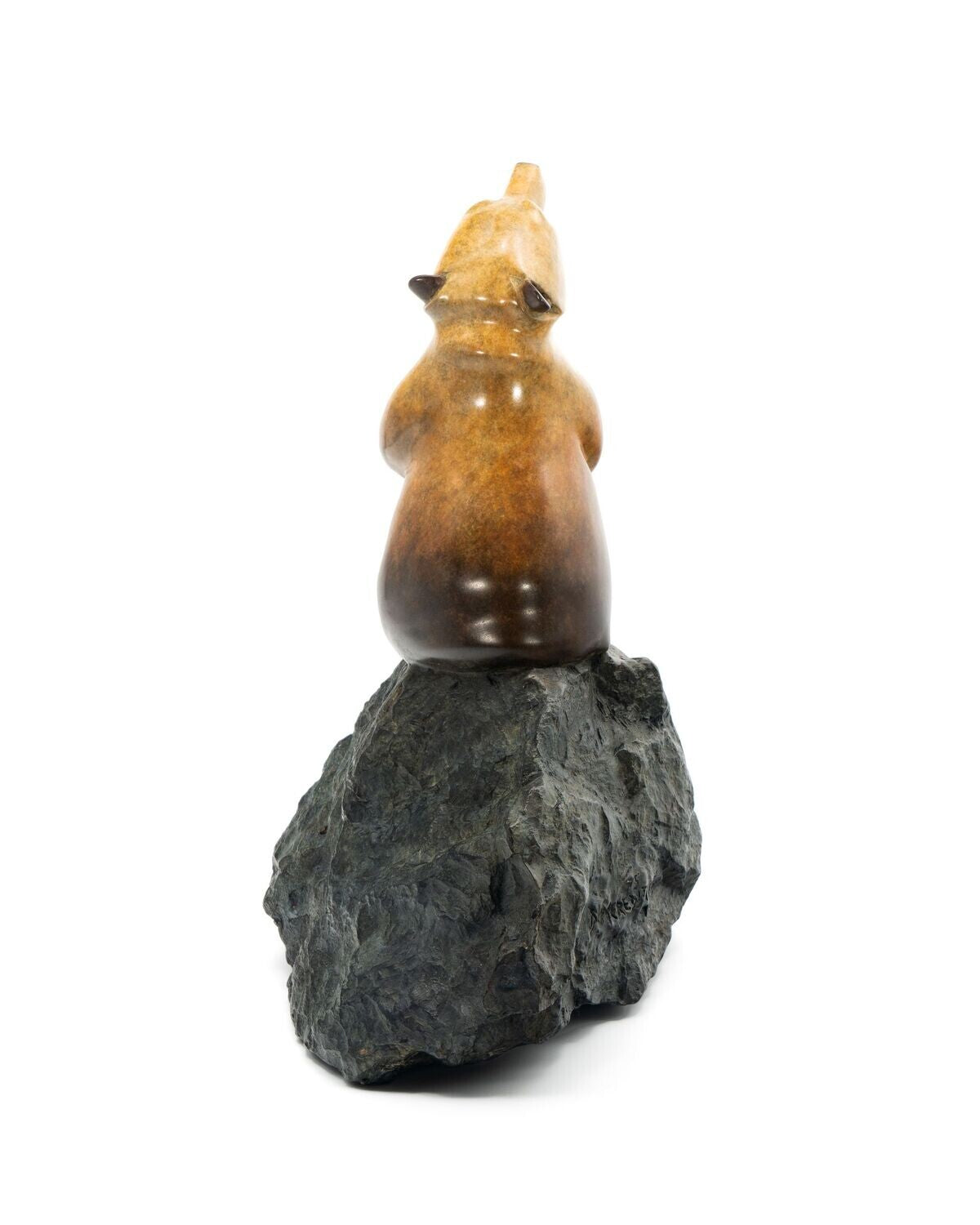 Decorative object resembling a bear on a rock with a white background