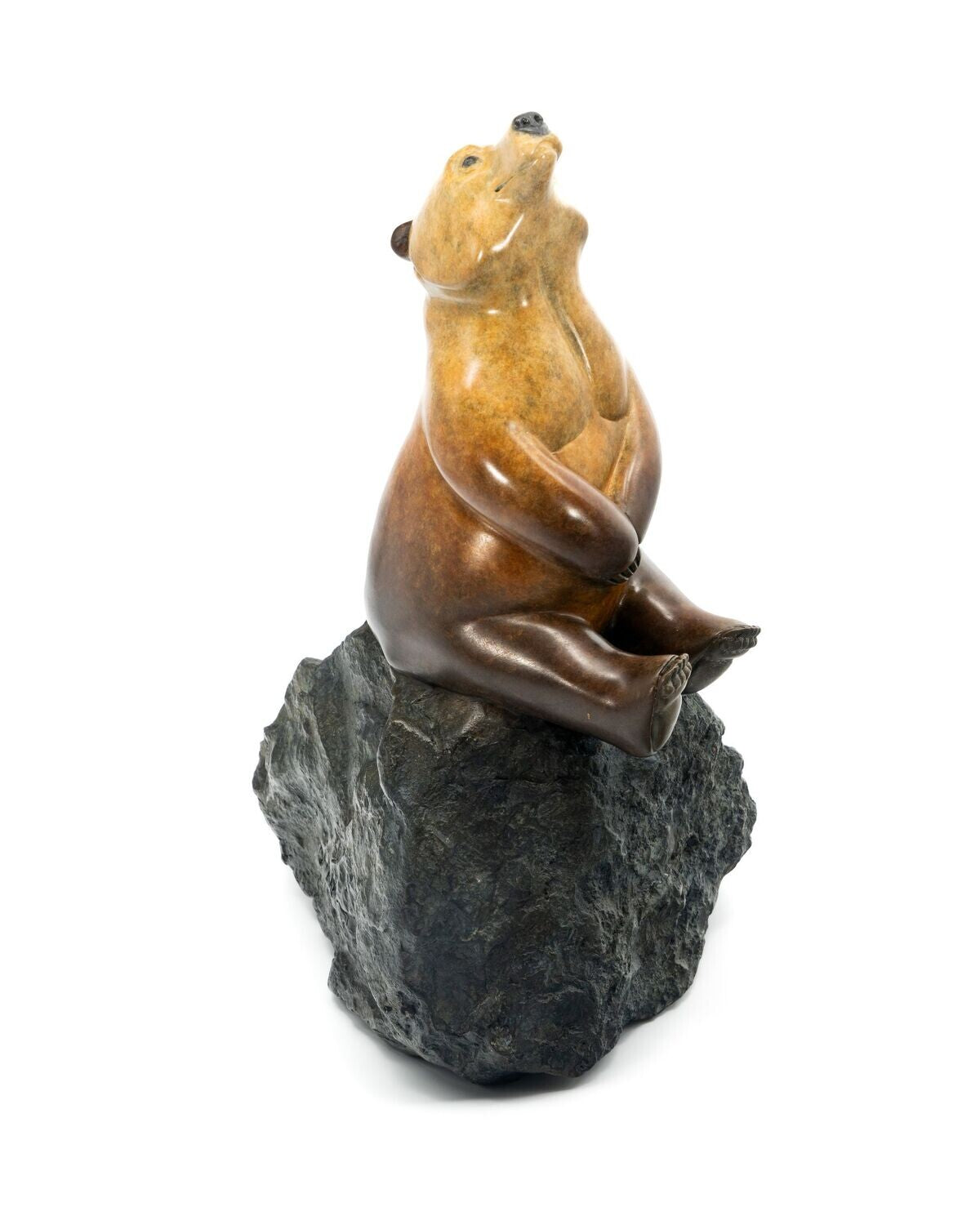 Bear sculpture on a rock with a white background