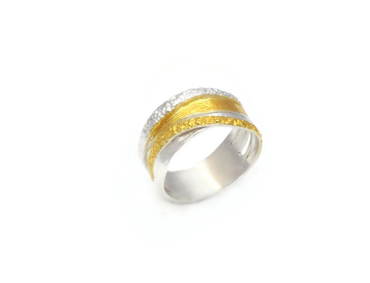 Two-tone silver and gold ring on a white background