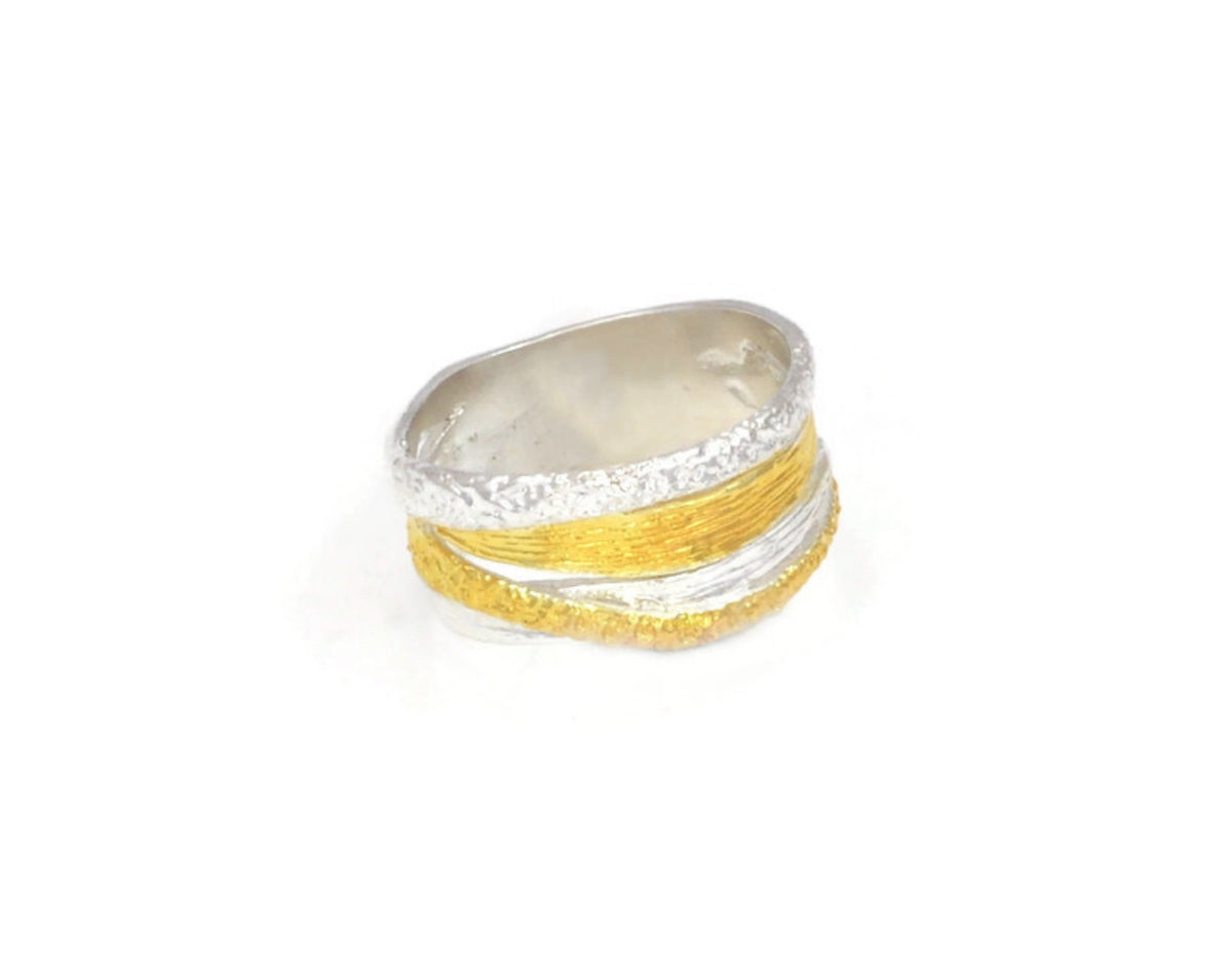 Two-tone silver and gold ring on a white background