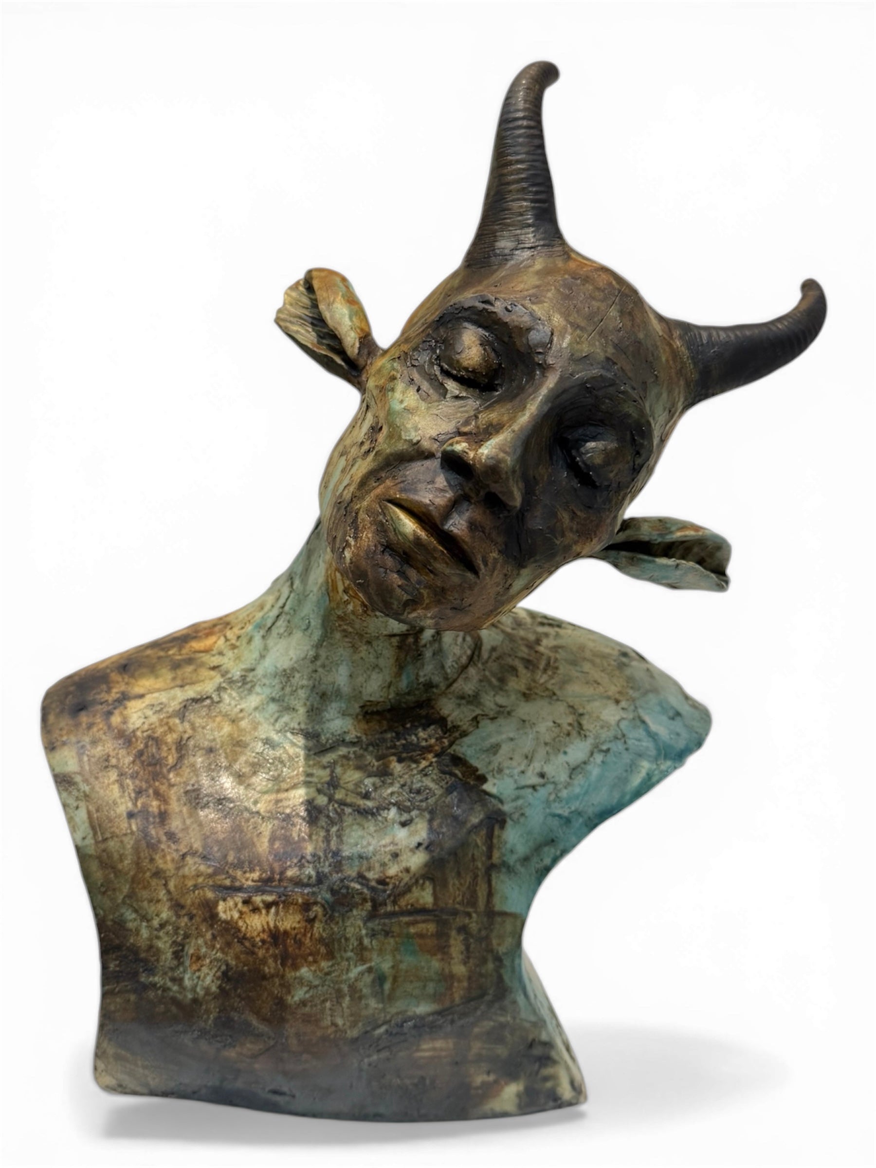 ceramic sculpture of a creature with a humanoid head and bull-like features on a white background