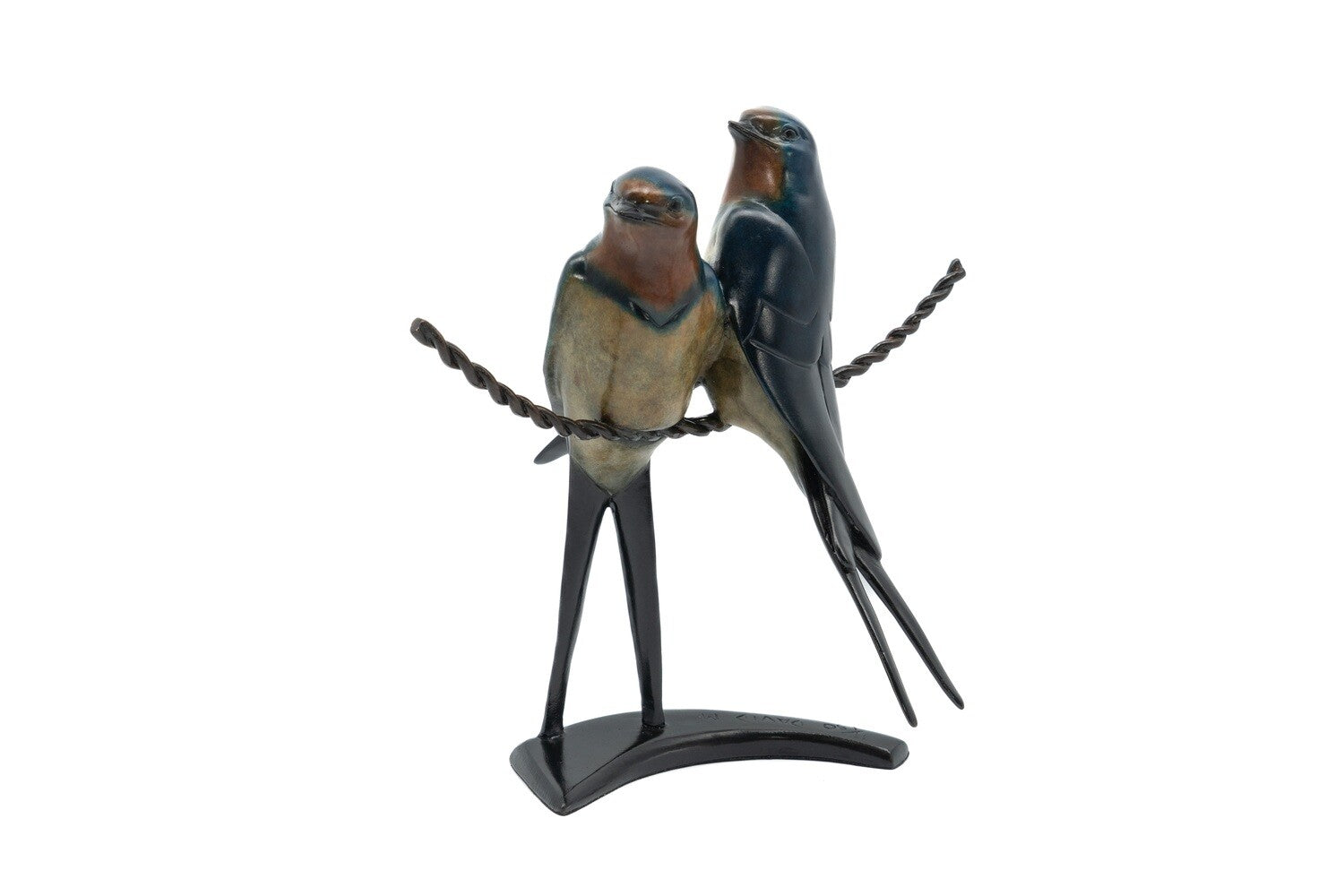 Statue of two birds perched on a branch with a white background