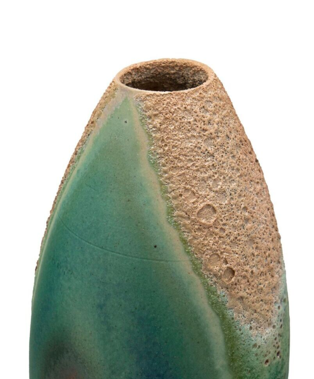Ceramic vase with textured surface and gradient color from green to beige on a white background