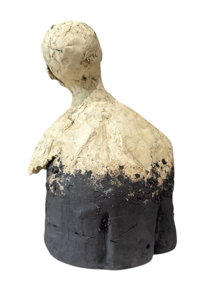 Abstract sculpture of a human figure with a white top and black bottom on a white background