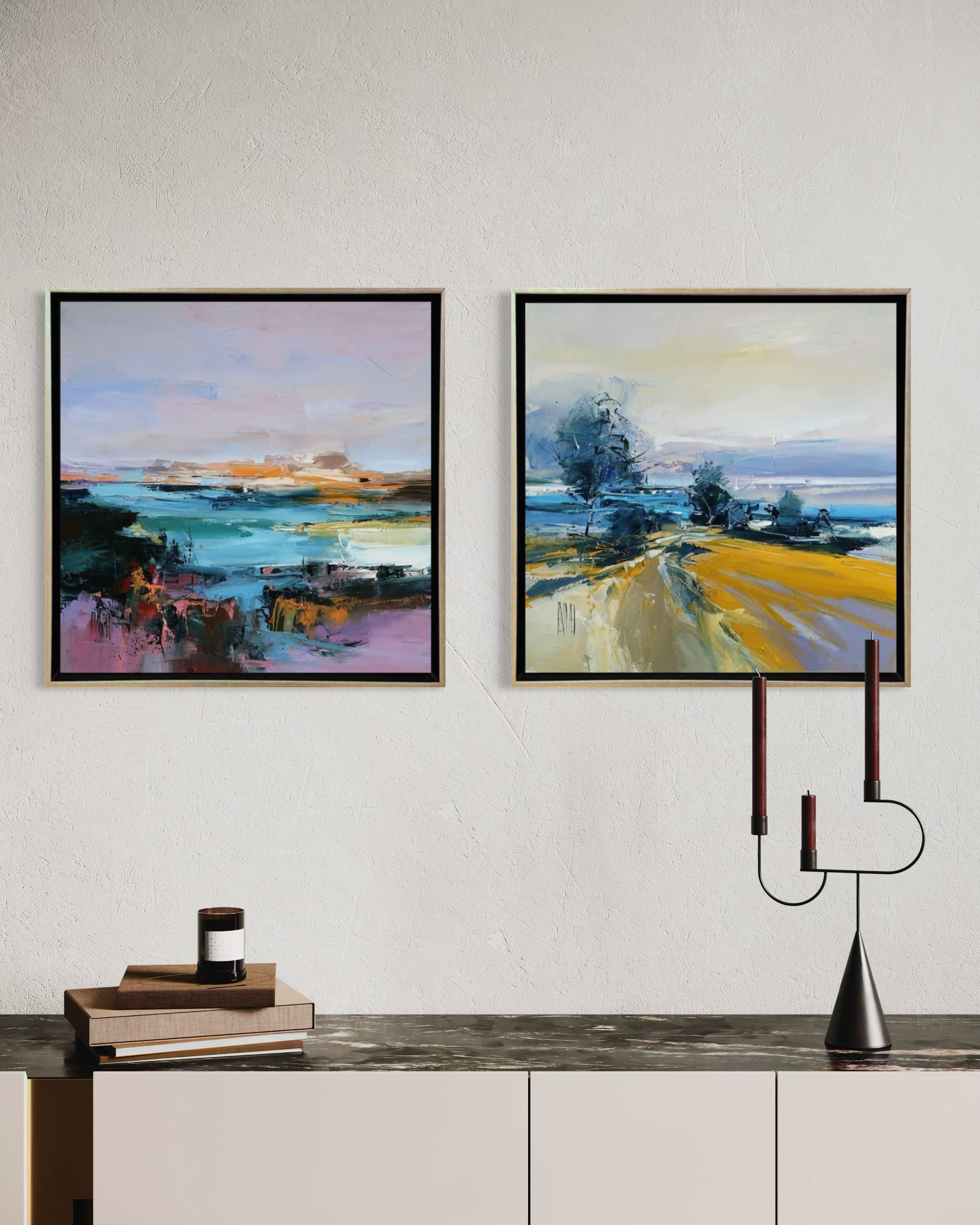 Two framed paintings on a wall above a console table with decorative items.