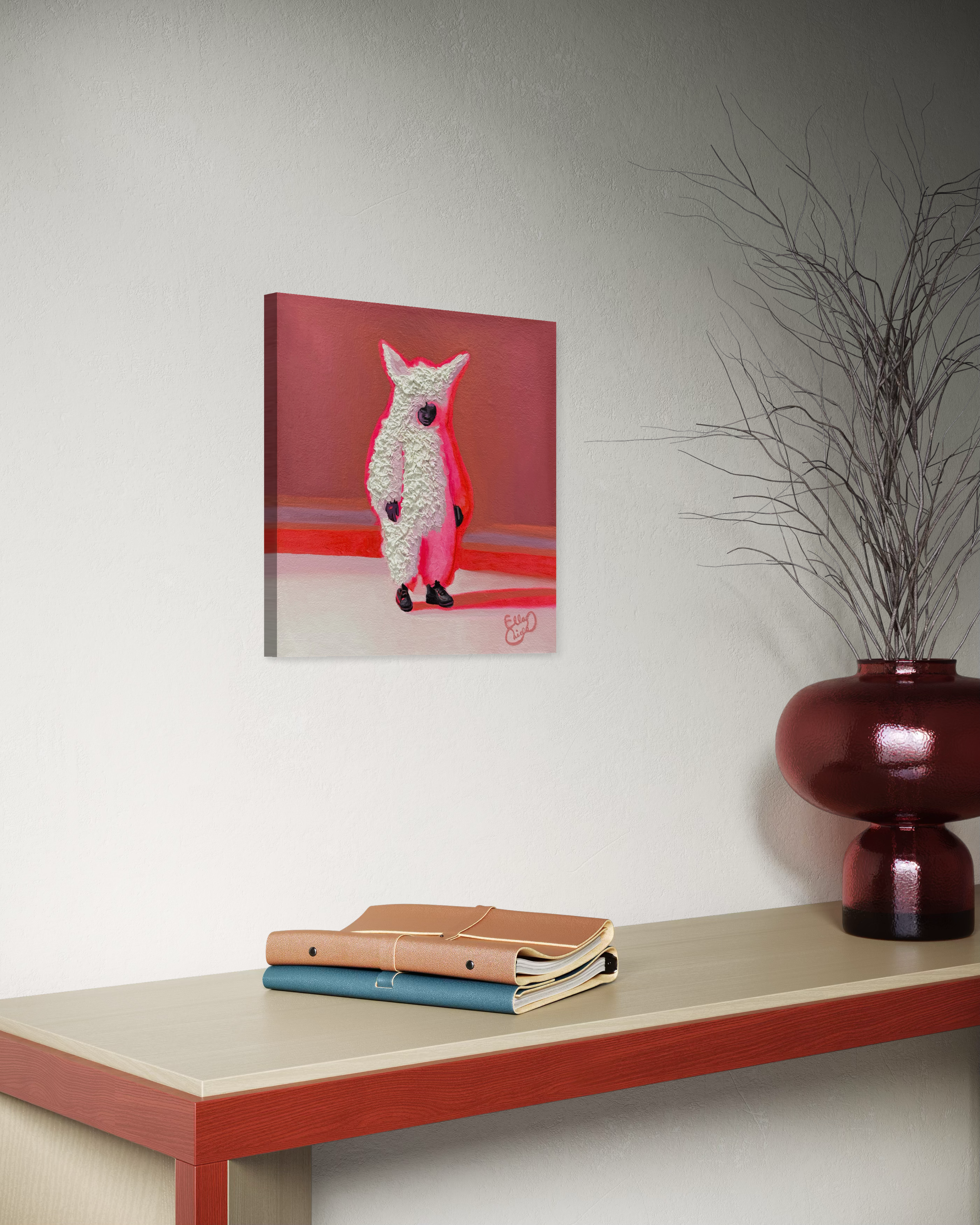 Canvas print of a person in a white fluffy suite on a red background hanging on a wall above a table with books and a vase.