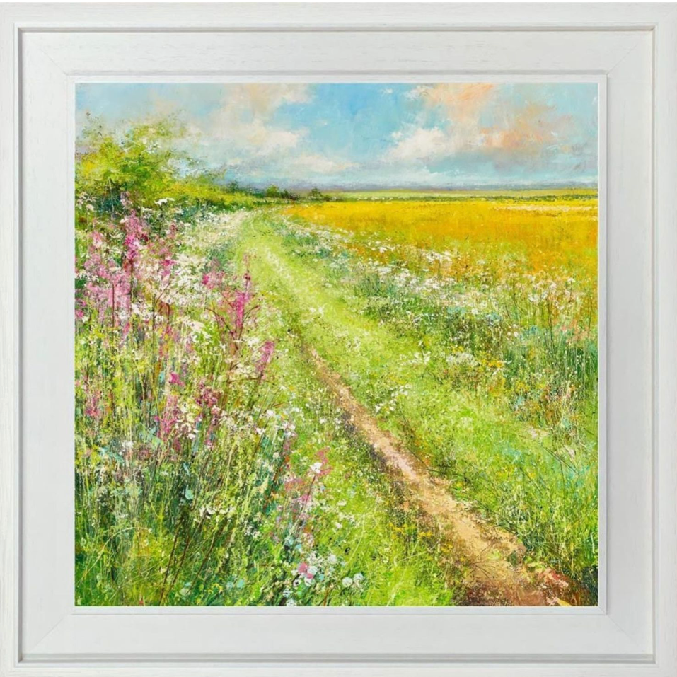 Framed artwork of a path through a field with wildflowers and a blue sky.