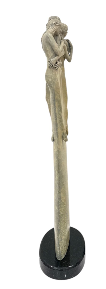 Decorative pen holder with a figurine on a white background