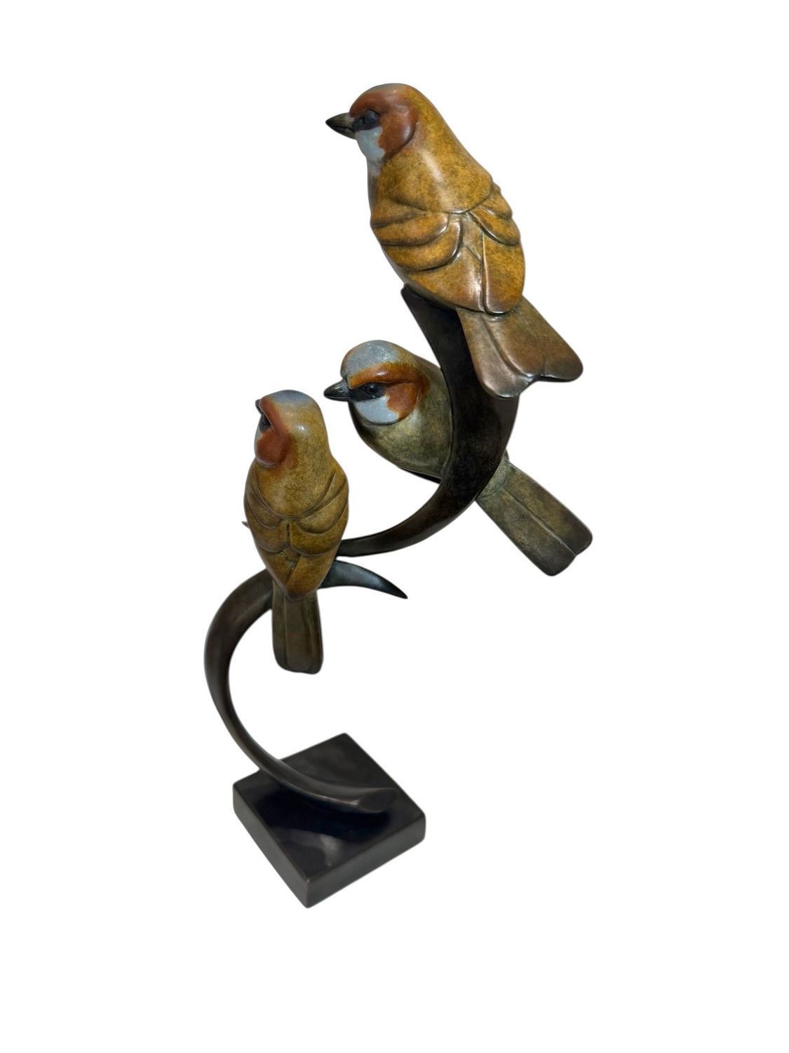 Decorative sculpture of three birds on a stand with a white background