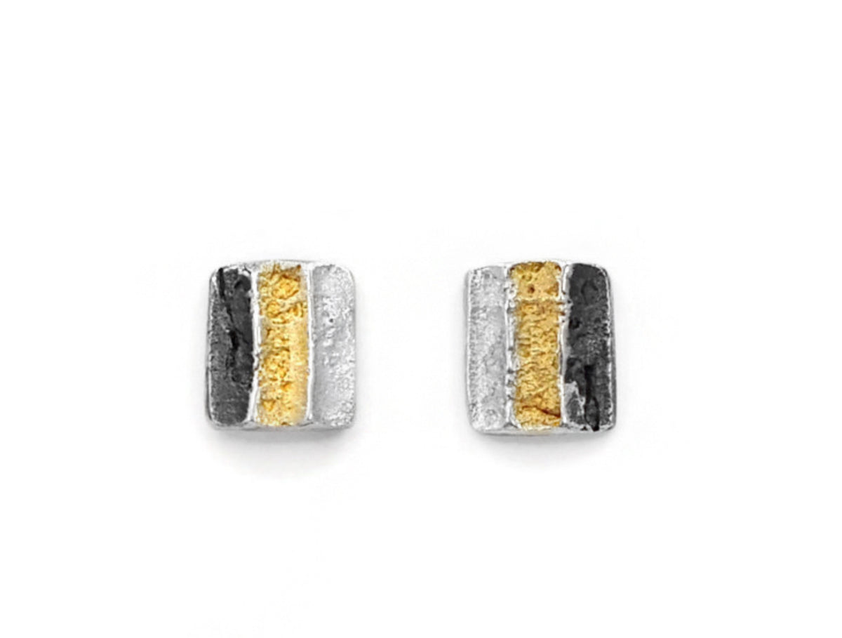 Pair of silver and gold earrings on a white background
