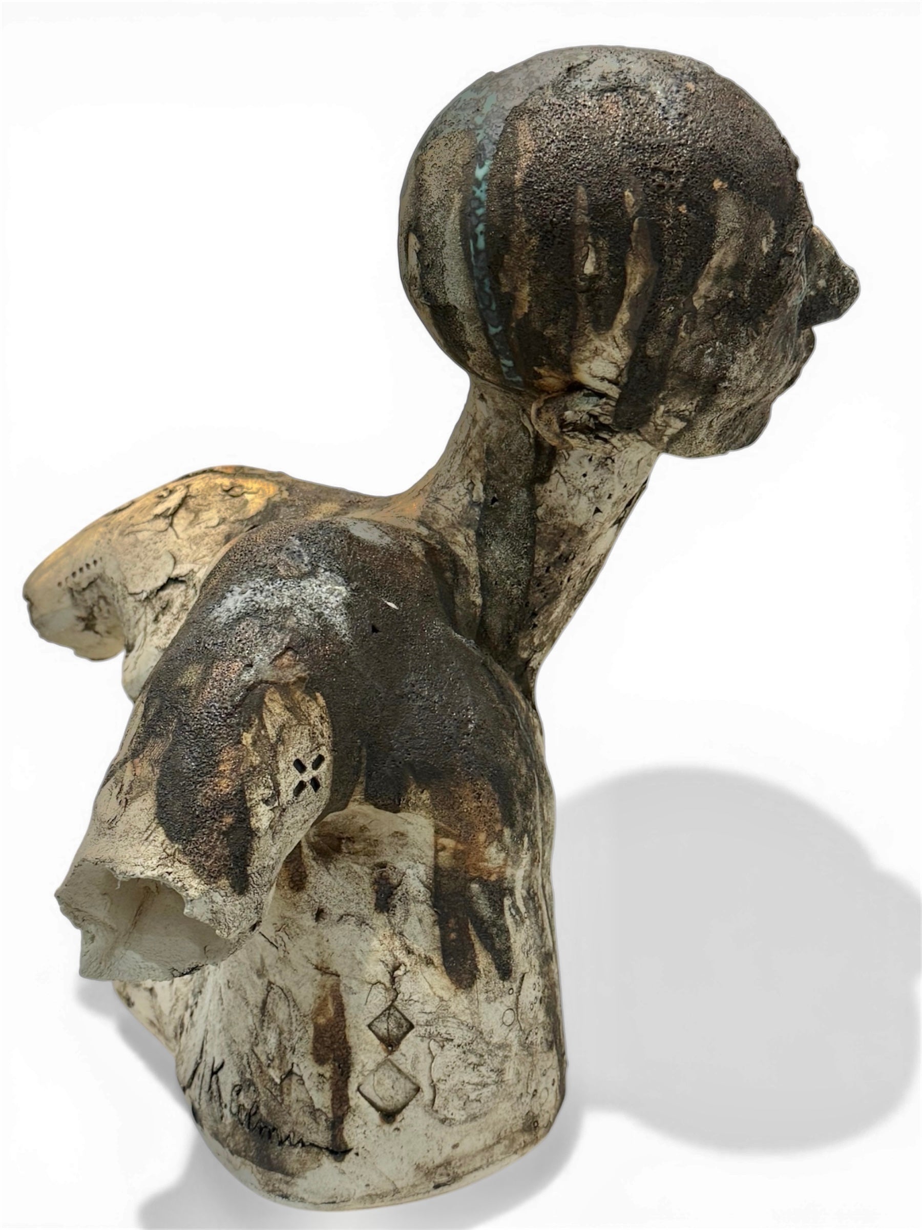 Ceramic sculpture of a figure on a white background