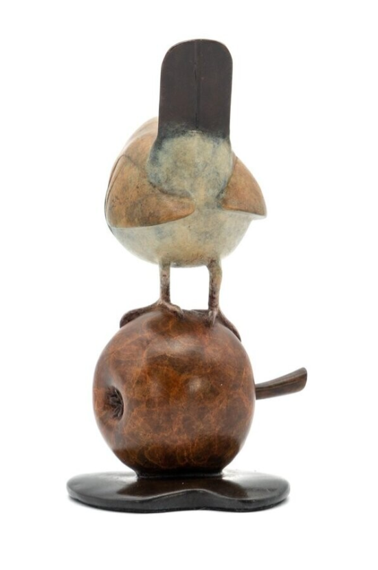 Decorative stone sculpture of a bird perched on a branch on a white background