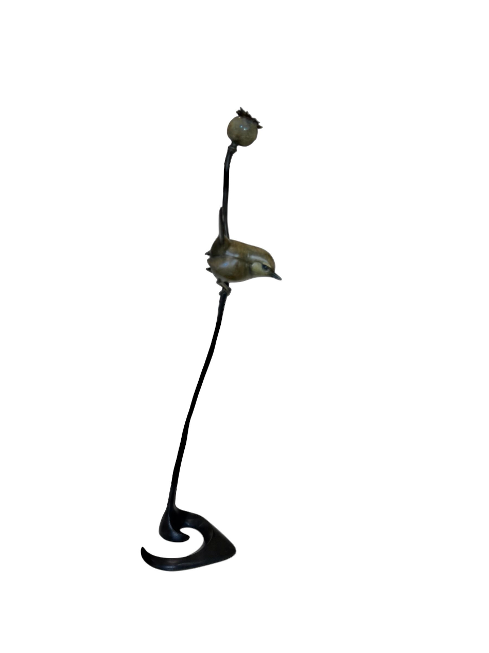 bronze sculpture of a wren on a white background