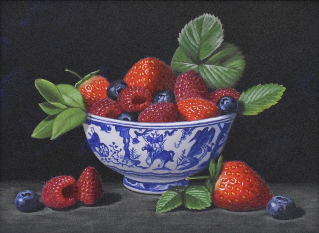 Still life painting of a blue and white bowl filled with strawberries and blueberries on a dark background.