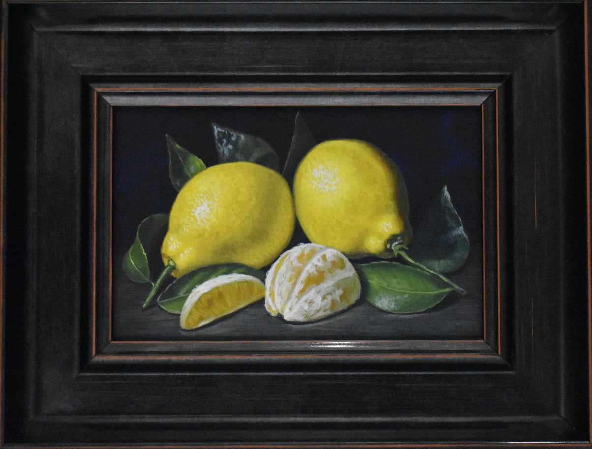 Framed artwork of lemons with a dark background