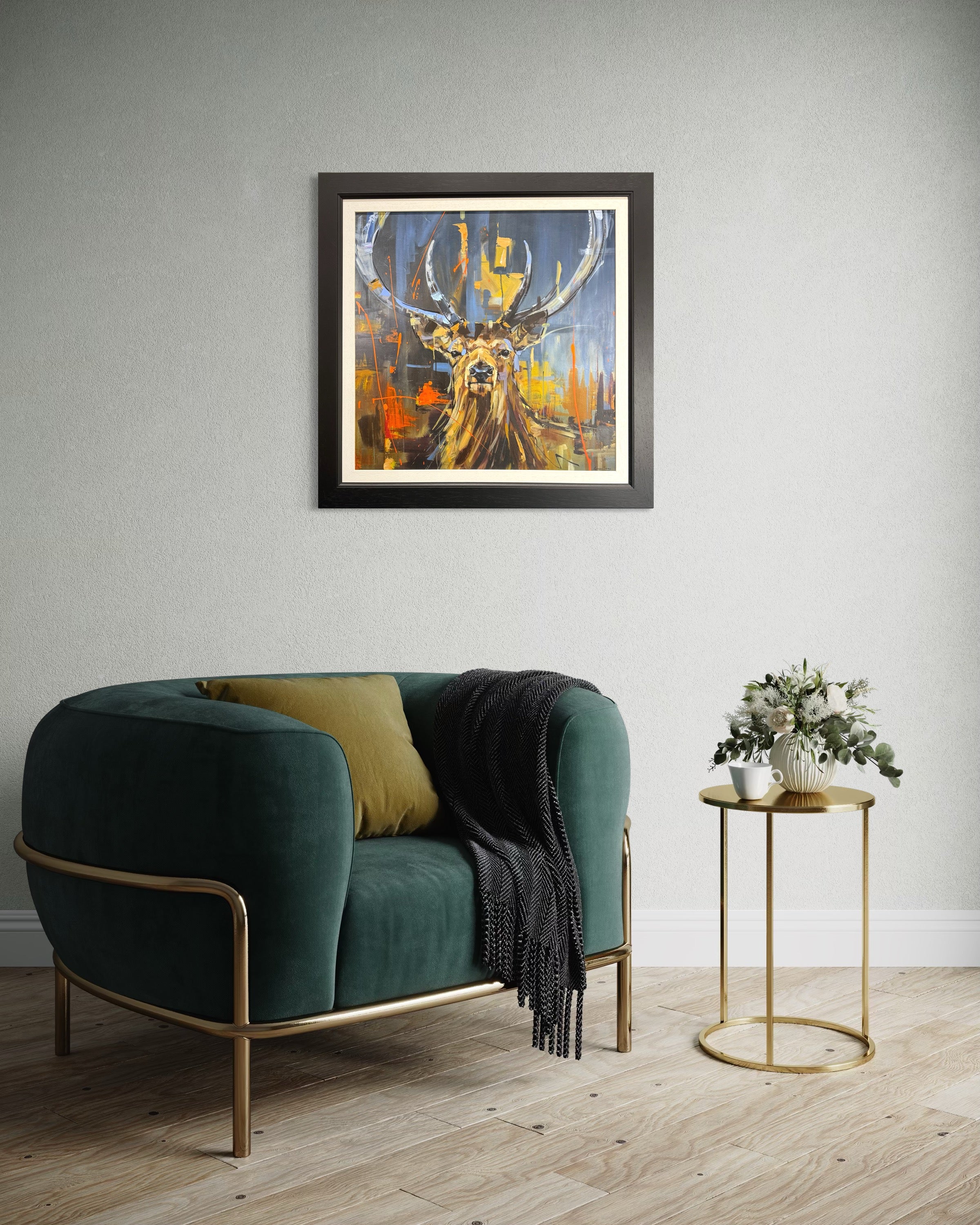Modern living room with a green sofa, gold side table, and abstract stag painting.
