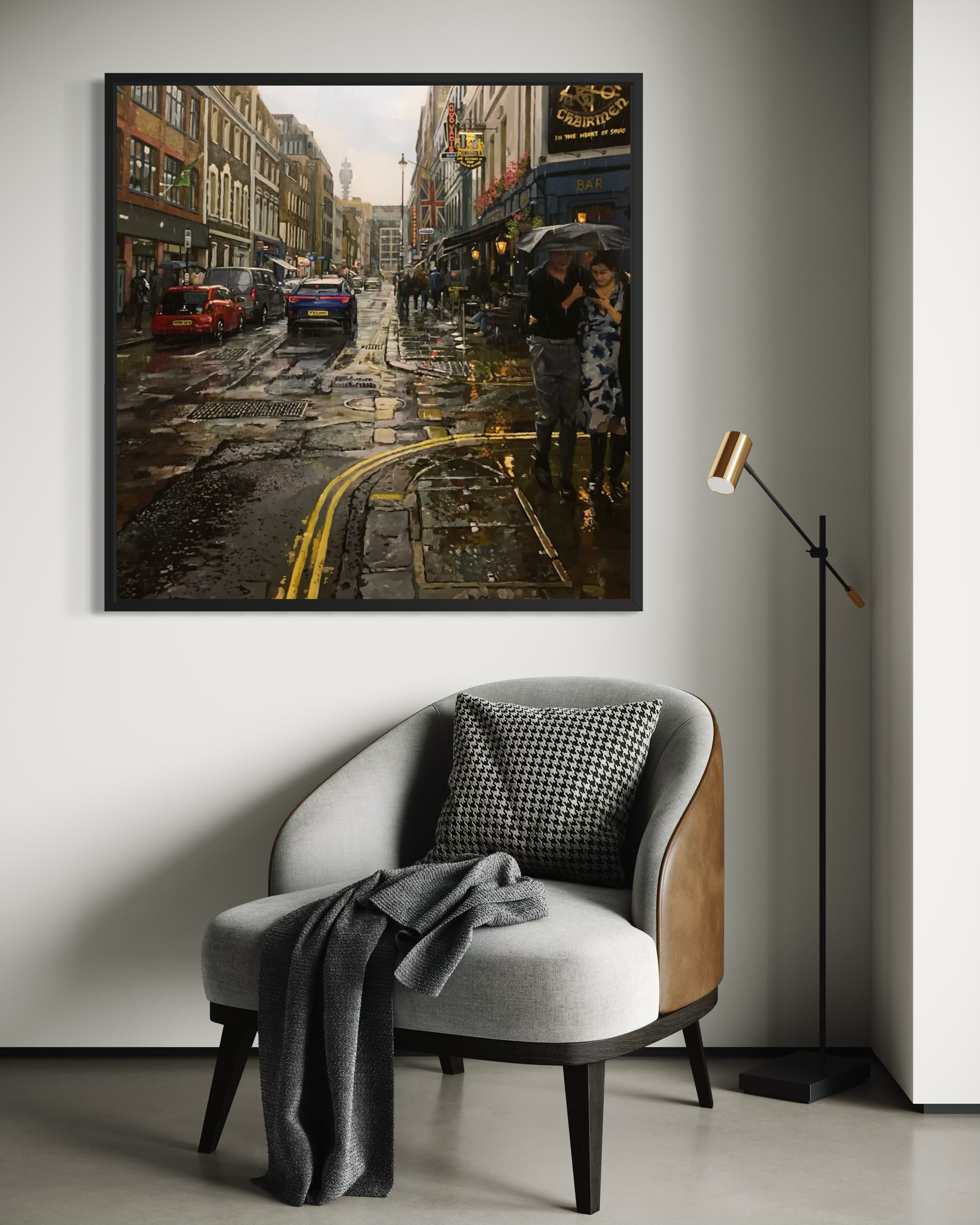 Framed london cityscape print on a wall above a modern chair with a lamp.