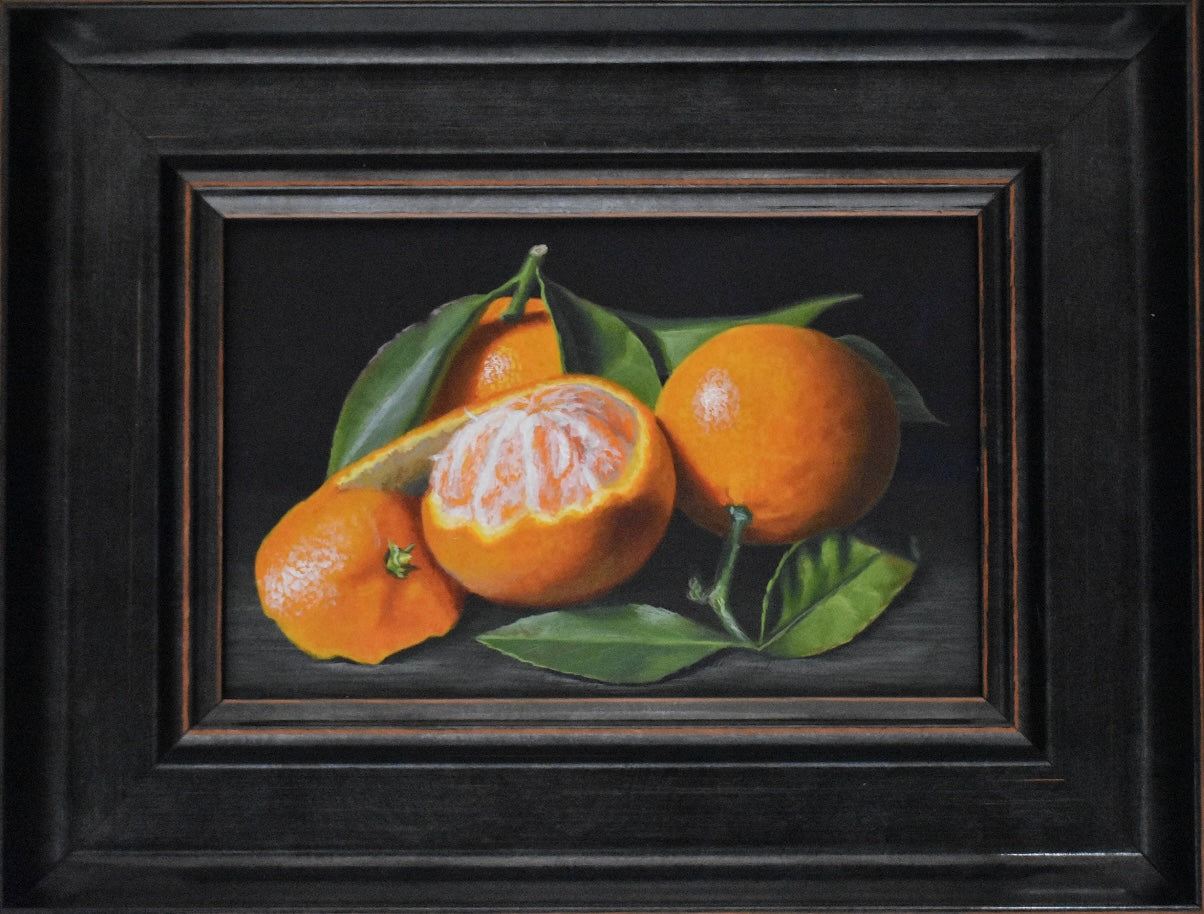Framed painting of oranges with leaves on a dark background