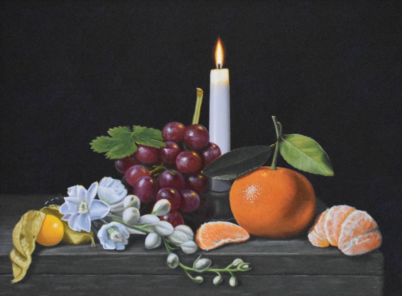 Still life with fruits and a candle on a dark background
