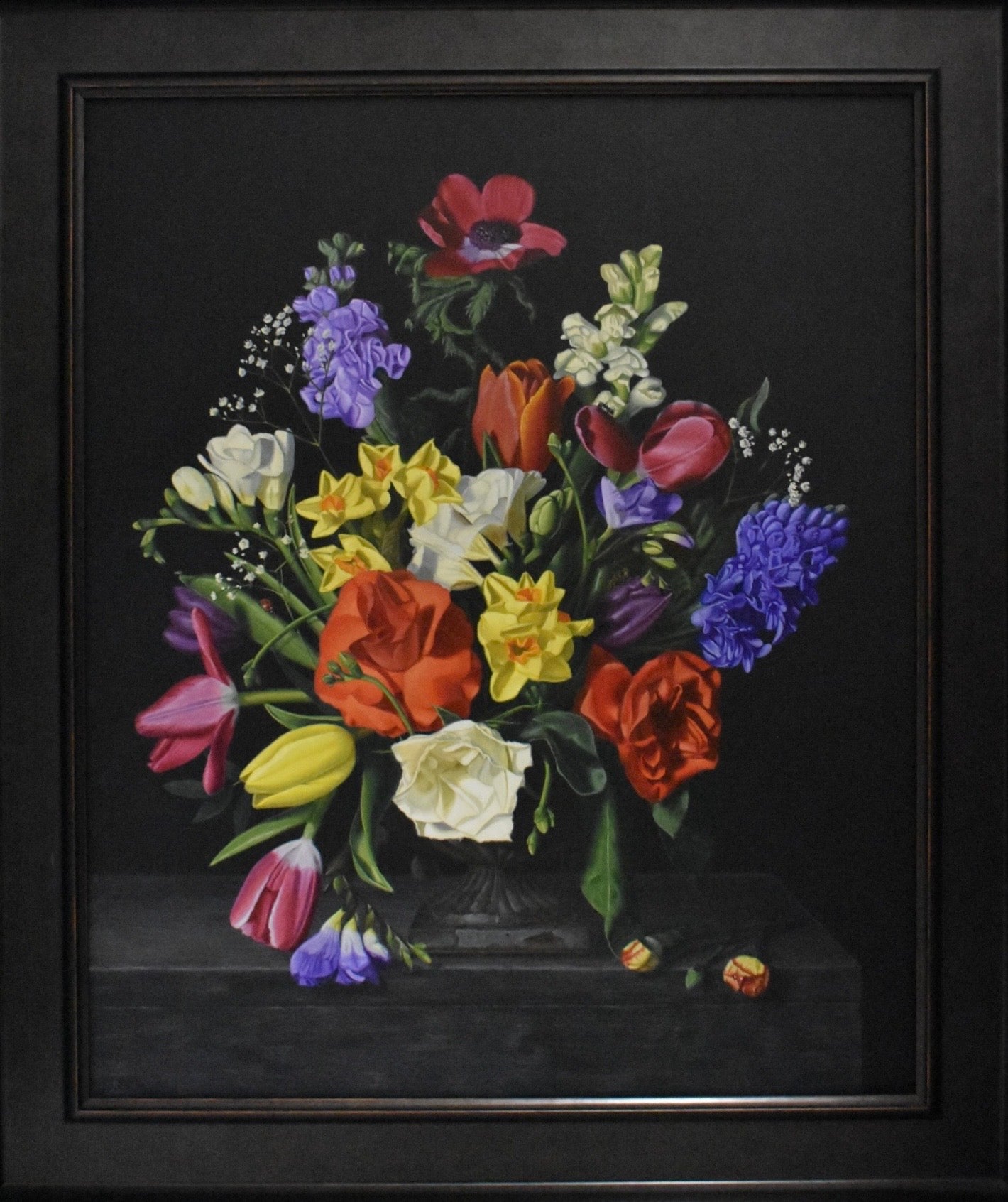 Framed still life painting of a bouquet of flowers on a black background