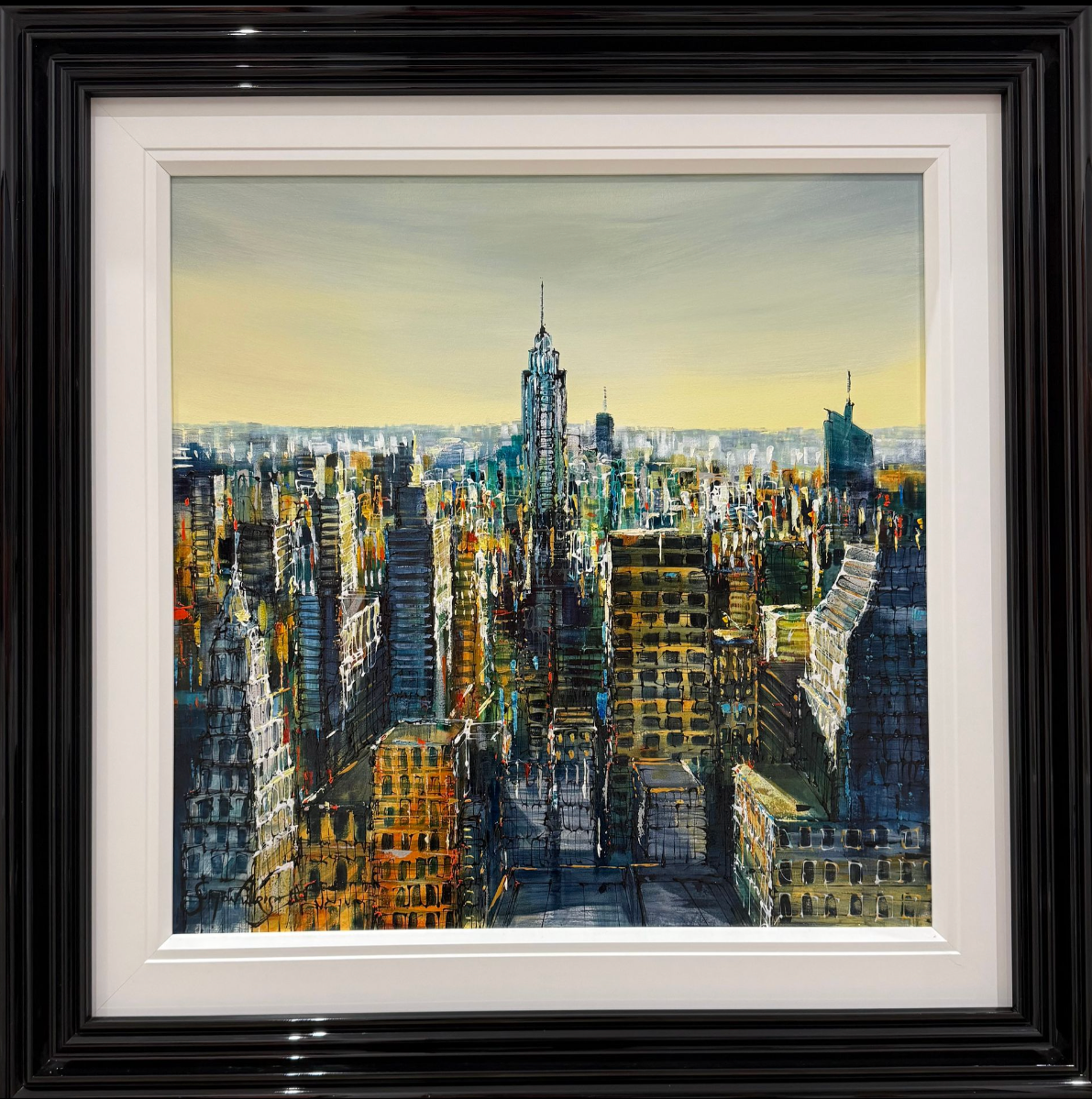 Framed painting of a cityscape with tall buildings